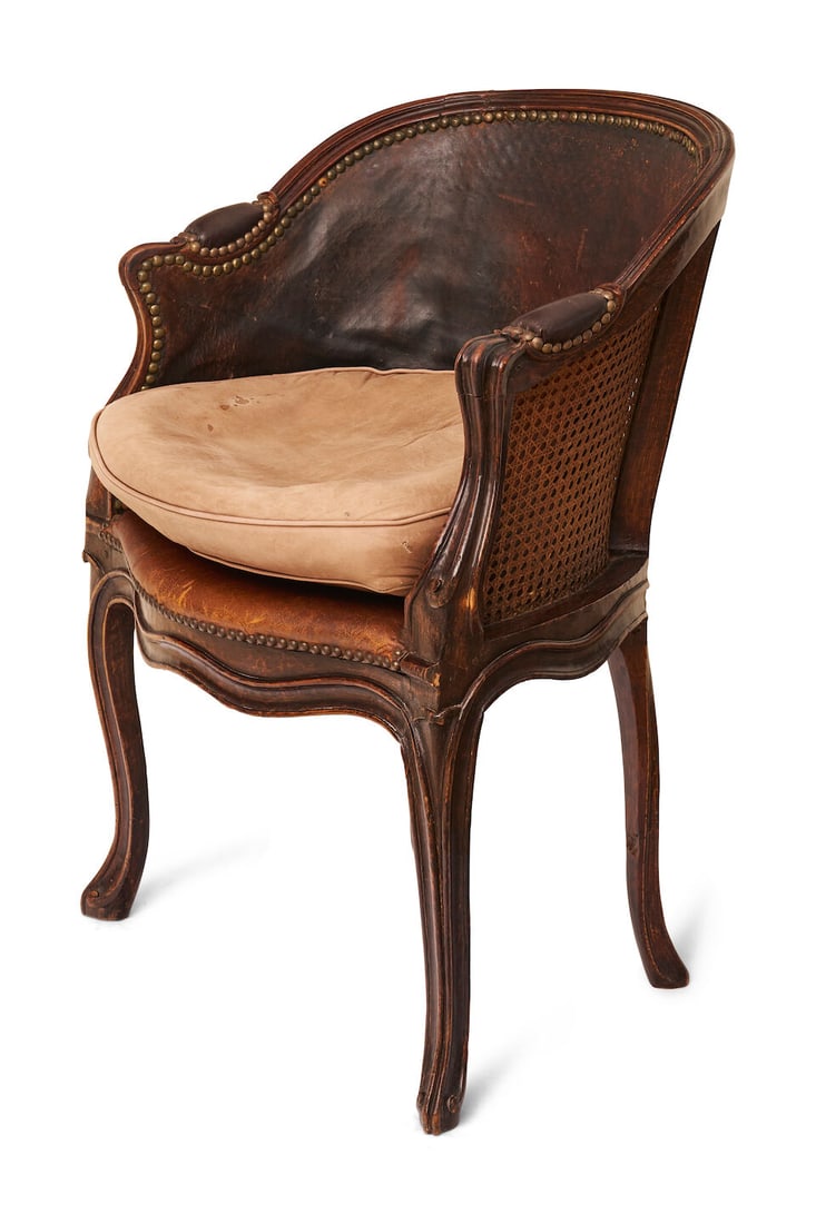 A petite Louis XV bergere, French, height: 85.0cm, width: 60.0cm, depth: 50.0cm: A petite Louis XV bergere, French, with caned back and seat, later leather upholstery, height: 85.0cm, width: 60.0cm, depth: 50.0cm For further information on this lot please visit Bonhams.com For fur