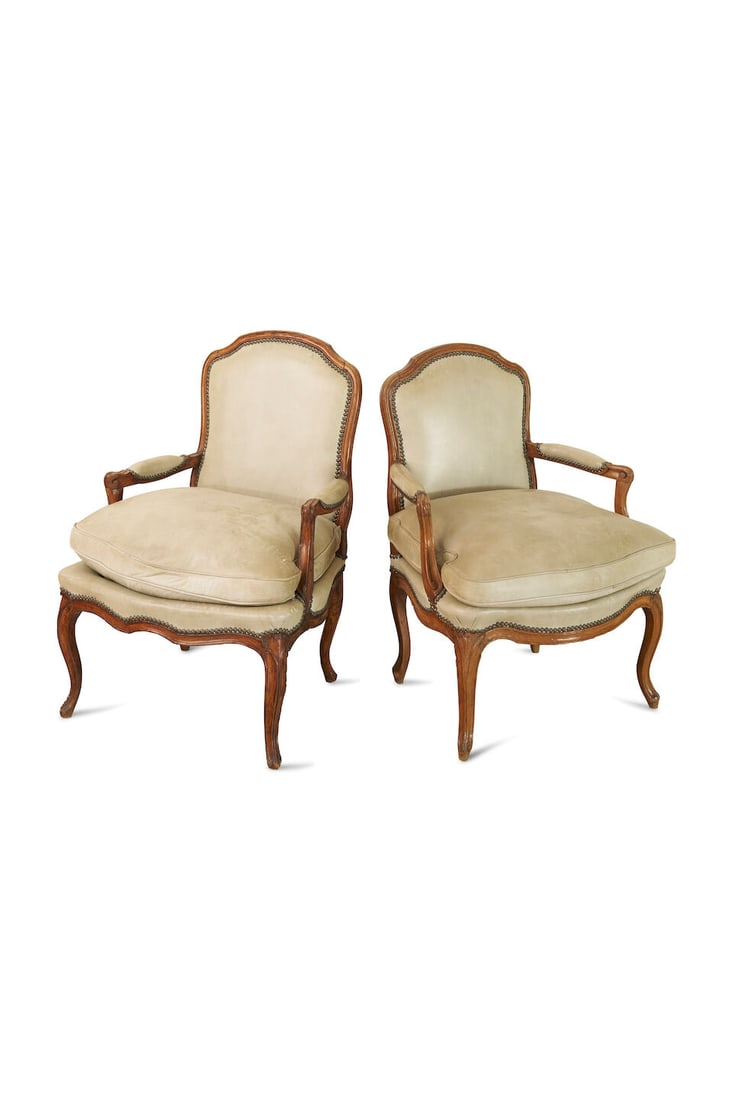 A near pair of Louis XV beech fauteuil, French, 18th century,: A near pair of Louis XV beech fauteuil, French, 18th century, on cabriole legs, recently upholstered in leather, with loose seat cushions, overall height: 93.5cm, seat height: 51.0cm, width: 68.0cm, d