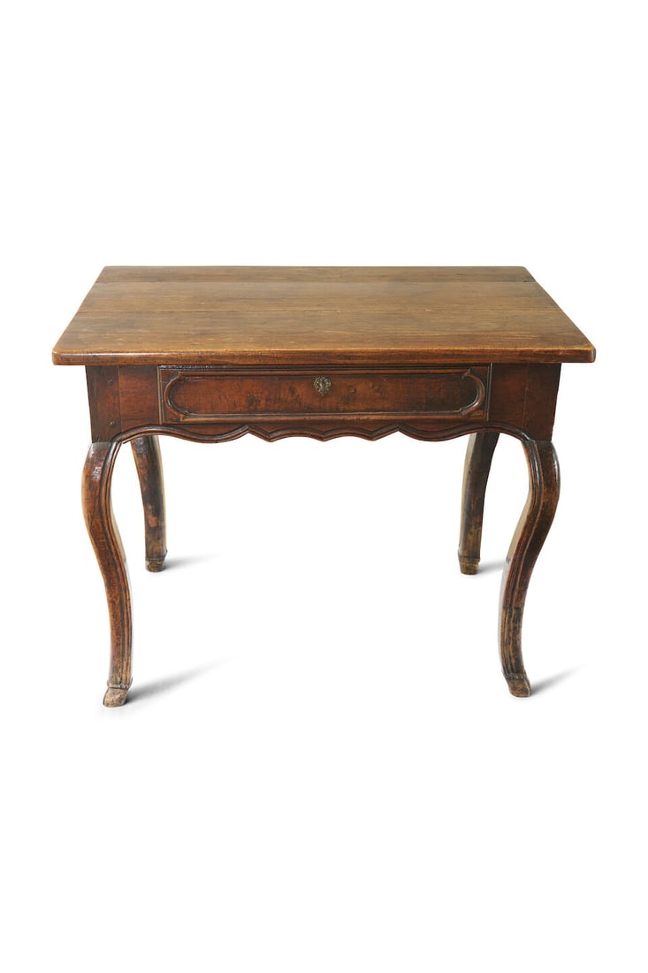 A Louis XV oak side table, Continental, 18th century: A Louis XV oak side table, Continental, 18th century of mixed woods, with rectangular top above a frieze drawer with a shaped apron, on cabriole legs, to cloven feet, height: 75.5cm, width: 95.5cm, de