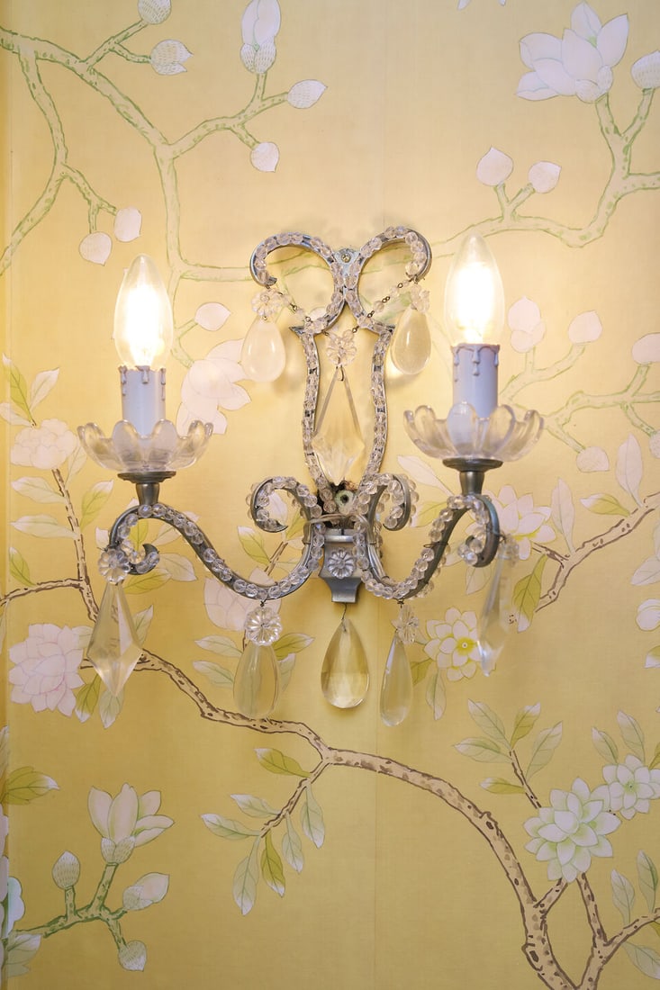 A pair of cut-crystal two-light wall sconces French, 19th century (2): A pair of cut-crystal two-light wall sconces French, 19th century The scrolling arms hung with diamond and pear-shaped drops, wired for electricity, height 30.0 cm, width 28.0 cm, depth 14.0 cm.
