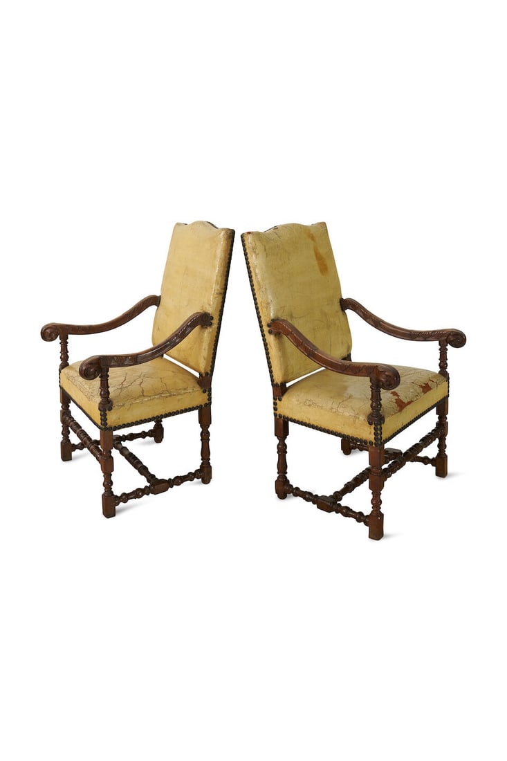 A pair of Louis XIV style fauteuil, French, 18th century: A pair of Louis XIV style fauteuil, French, 18th century with acanthus carved scroll arms, above a close nail seat and back upholstered in leather, raised on turned legs joined by H stretcher,