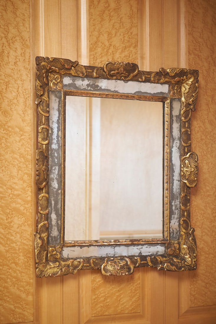 A Louis XV giltwood mirror, French, 18th century: A Louis XV giltwood mirror, French, 18th century with carved and painted wood, original plate in panels, with original Parisian gilder and framer label, 'L. Morenvillier, Doreur - Encadreur, 8 Rue Mar