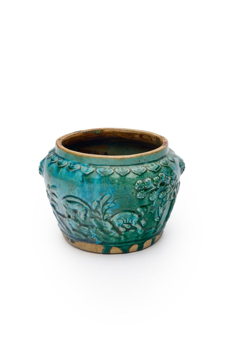 A green glazed jardiniere, China, 19th century, height: 17.0cm: A green glazed jardiniere, China, 19th century, decorated with deer, rooster and dragons amongst foliage, David Jones Art Gallery label attached to the inside of the jar, height: 17.0cm For further in