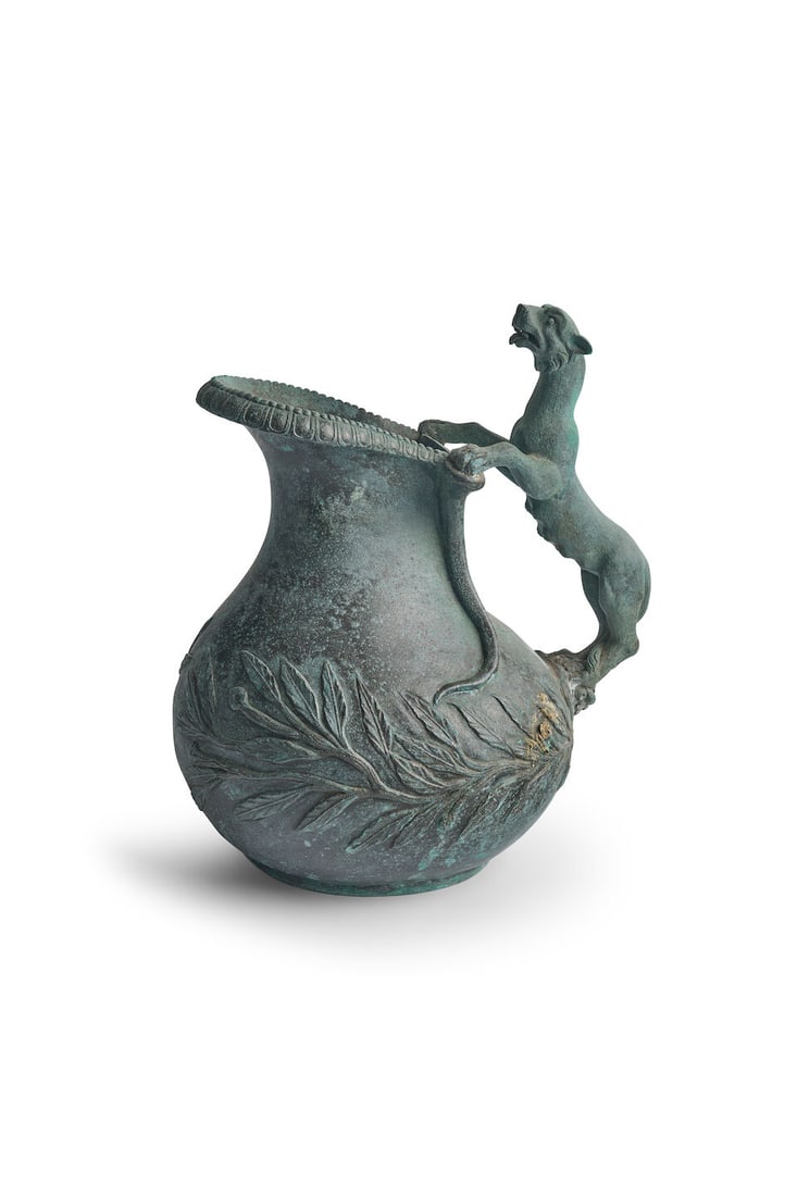 An Italian Grand Tour Askos, after the Antique: An Italian Grand Tour Askos, after the Antique with panther handle and a wreath of foliage, modelled after the Roman original from Pompeii now in the Naples Museum, height: 21.0cm, depth: 22.0cm For f