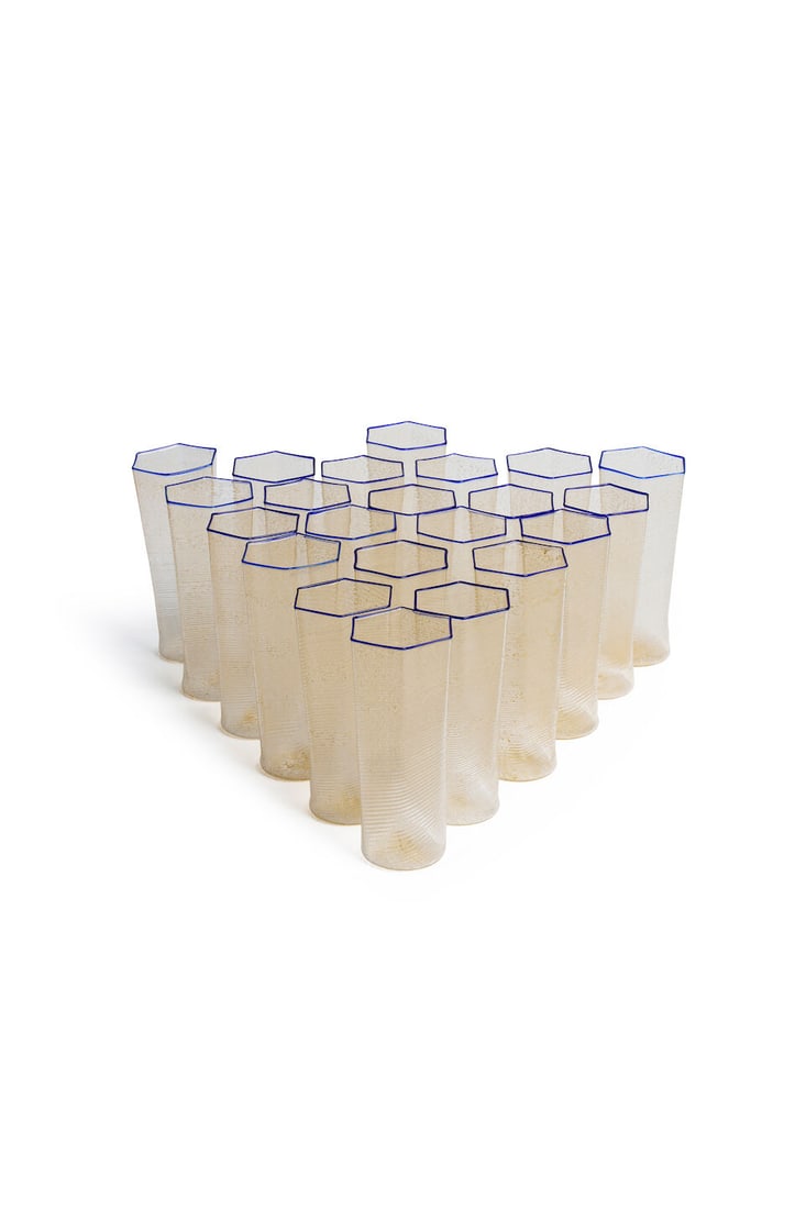 Carlo Scarpa for Venini, set of 22 highball tumblers blown Murano glass,: Carlo Scarpa for Venini, set of 22 highball tumblers blown Murano glass, clear hexagonal form with gold flecks and cobalt rim, height: 13.5cm For further information on this lot please visit Bonhams.c