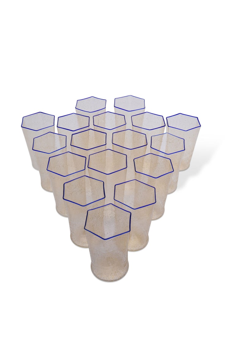 Carlo Scarpa for Venini, set of 17 tumblers, blown Murano glass,: Carlo Scarpa for Venini, set of 17 tumblers, blown Murano glass, clear hexagonal form with gold flecks and cobalt rim, height: 9.0cm For further information on this lot please visit Bonhams.com For fu