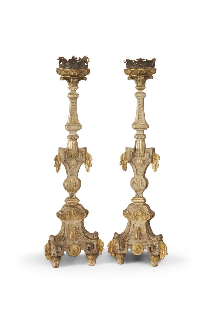 A pair of Baroque-style silver-gilt carved wooden torchieres Italian, 18th century (2): A pair of Baroque-style silver-gilt carved wooden torchieres Italian, 18th century Shaped triangular bases raised on three feet, silver-gilt carved panels to front and blue-painted panels to the rear,