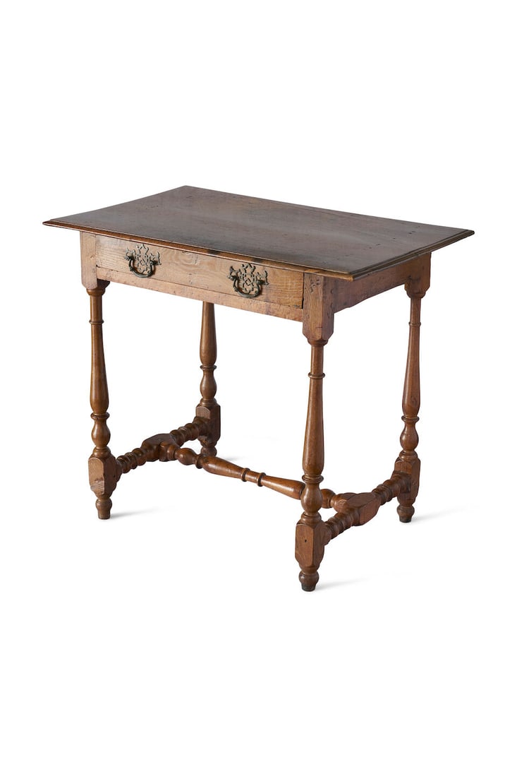 A provincial oak side table English, 18th century: A provincial oak side table English, 18th century rectangular top above a frieze drawer, on ring turned legs with bobbin turned H stretcher, height: 74.5cm, width: 84.5cm, depth: 54.0cm For further in