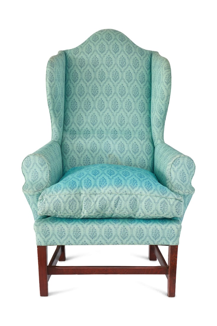 A Provincial oak wingback armchair: A Provincial oak wingback armchair in the Georgian style, with chamfered legs and stretcher, upholstered in block print linen, overall height: 126.0cm, seat height including cushion: 60.0cm, width: 90