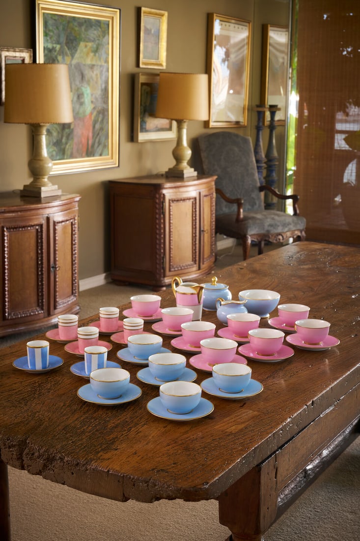 A Limoges part tea and coffee service French, 20th century: A Limoges composite part tea and coffee service French, 20th century Comprising eight teacups and eight matching saucers in the 'Pourpre de rose' pattern, with creamer and saucer; five teacups and fiv