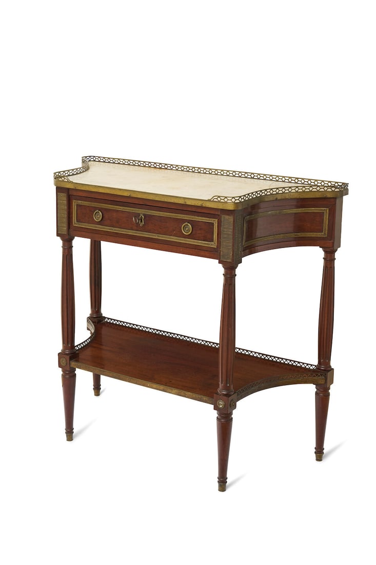 A Louis XVI style dressing table: A Louis XVI style dressing table repaired white marble top, within a pierced brass gallery, above a frieze drawer upon tapered legs, with under tier, height: 87.0cm, width: 96.0cm, depth: 39.0cm This 