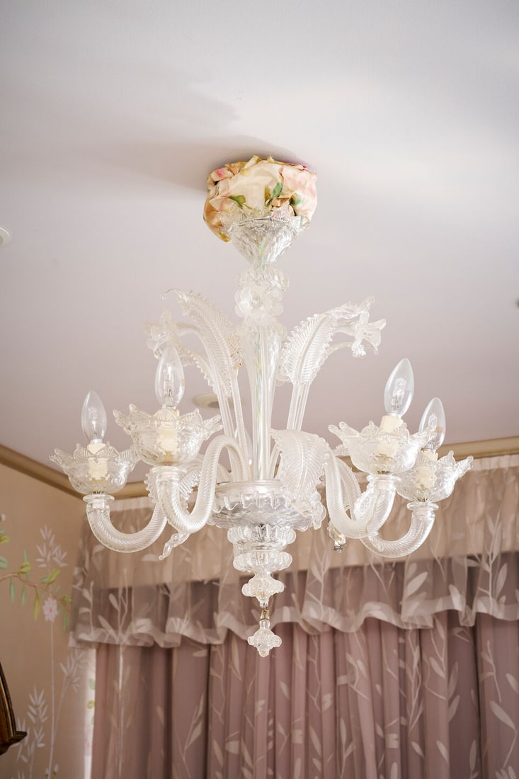 A Murano glass five-light chandelier Italian, 20th century: A Murano glass five-light chandelier Italian, 20th century Scrolling leaf and foliate design, clear and frosted glass, wired for electricity, 67.0cm drop. This lot is subject to the following lot symb