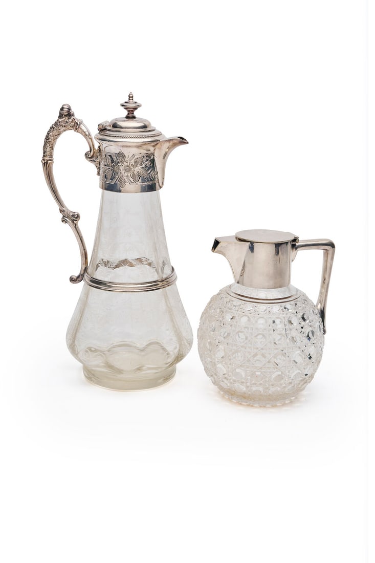 Hukin & Heath | Claret jug and a Victorian claret jug Maker's mark H&H, Birmingham, circa 1910 (2): Hukin & Heath | Claret jug and a Victorian claret jug Maker's mark H&H, Birmingham, circa 1910 Design number 7608, after a design attributed to Christopher Dresser, the hinged lid with a tusk shaped h