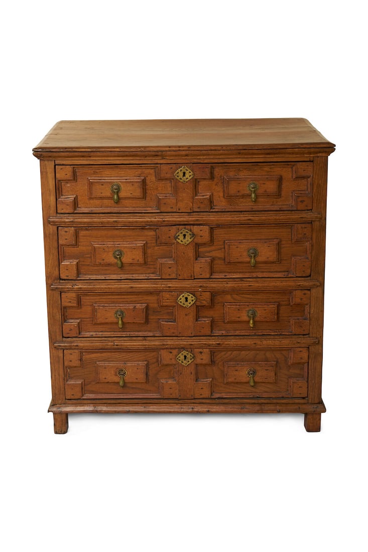 An early oak chest of drawers, English, 1700s,: An early oak chest of drawers, English, 1700s, with applied geometric mouldings to the drawers, the chest retains the original feet (carcass rails running through to become feet), height: 99.0cm,