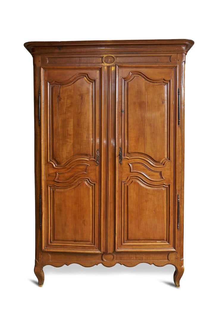 A Louis XV provincial armoire, French, 18th century,: A Louis XV provincial armoire, French, 18th century, of mixed timbers with oak and fruitwood, moulded cornice above two panelled doors, three internal shelves, raised on short cabriole legs, height: 2