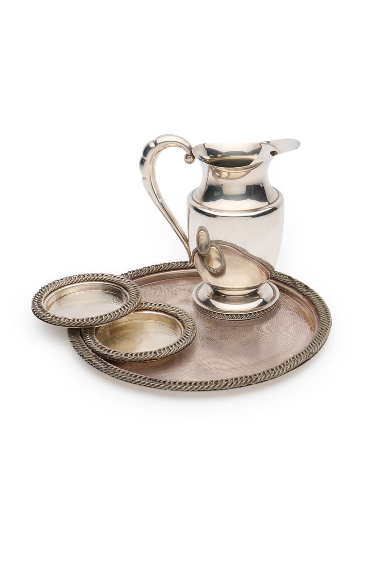 Hermès | Serving tray and wine coasters signed HERMÈS PARIS, 20th century: Hermès | Serving tray and wine coasters signed HERMÈS PARIS, 20th century Engine turned with rope border, silver plate; together with a Hecworth Sheffield plate water jug, diameter tray: 30.