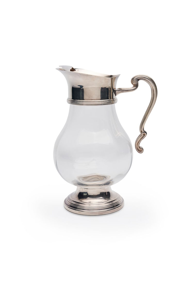 Christofle | a water pitcher, marked CHRISTOFLE PARIS, 20th century: Christofle | a water pitcher, marked CHRISTOFLE PARIS, 20th century Albi design, with scrolling handle and ribbed collar and base, silver plate, height 18.0cm, weight 1250gms. For further information