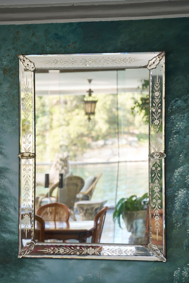 A Venetian mirror, Italy, 20th century,: A Venetian mirror, Italy, 20th century, with etched borders and applied decorative glass panels, 118.0 x 86.0cm This lot is subject to the following lot symbols: TP TP Please note this lot is
