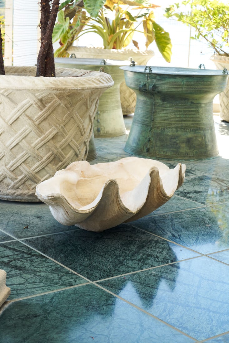A giant clam shell: A giant clam shell of typical form, 23.0cm high, 69.0cm wide, 41.0cm deep This lot is subject to the following lot symbols: TP TP Please note this lot is available for collection by professional carri