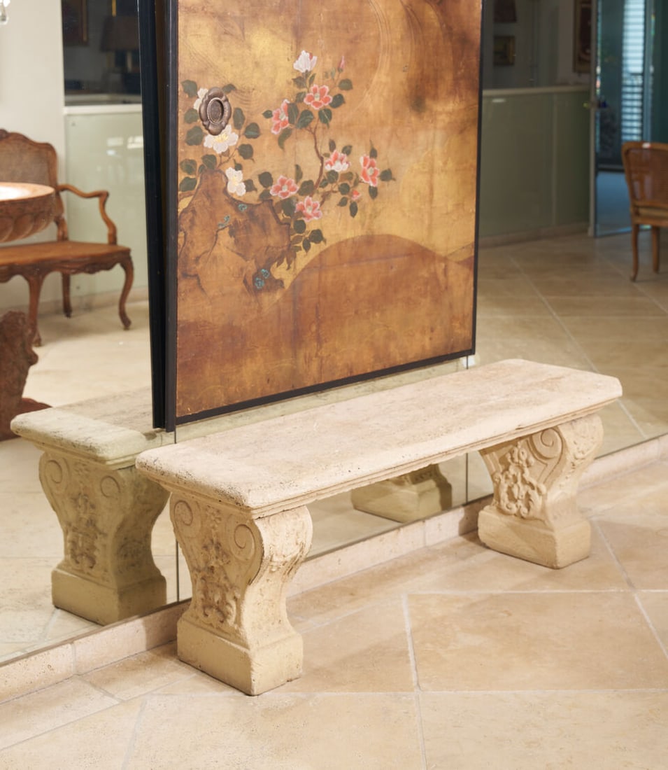 A near pair of stone bench seats, (2): A near pair of stone bench seats, in sandstone and composite material, with carved pedestal bases, height: 51.0cm, width: 144.0cm, depth: 43.0cm (2) This lot is subject to the following lot symbols: