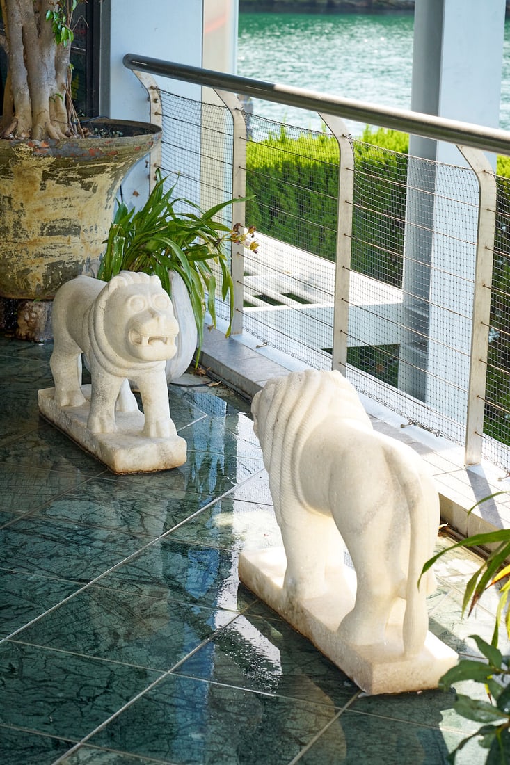 A pair of marble lions, India, 19th/20th century: A pair of marble lions, India, 19th/20th century with stylised manes, on integral bases, height: 59.0cm, length: 77.0cm, width: 22.0cm This lot is subject to the following lot symbols: W TP W Please