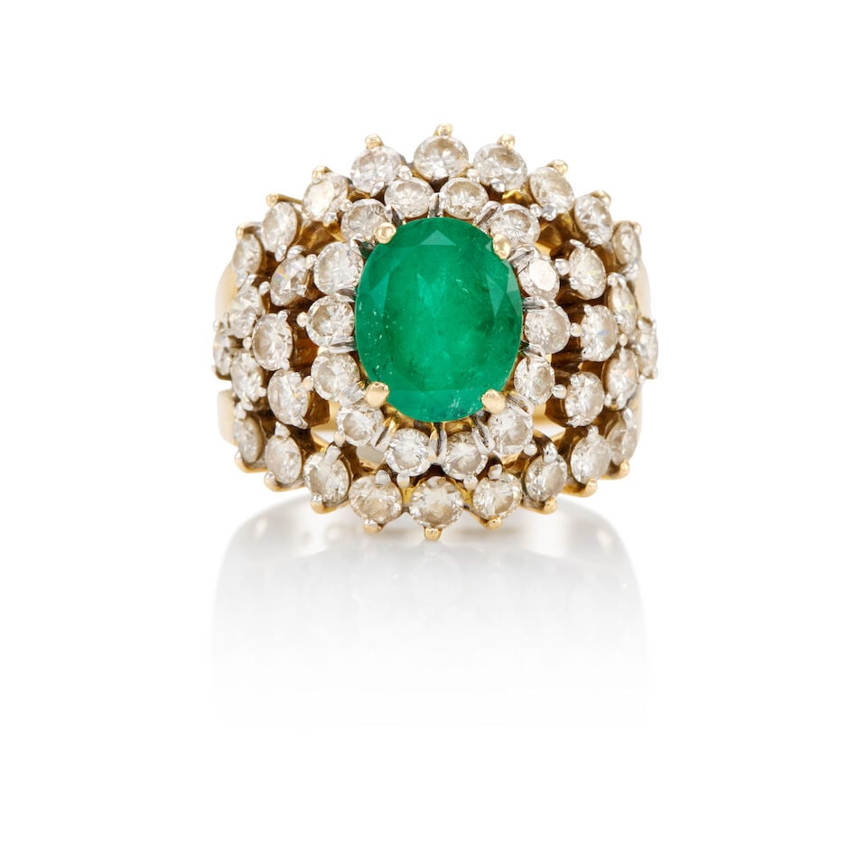 18K GOLD, EMERALD AND DIAMOND RING: 18K GOLD, EMERALD AND DIAMOND RING • 18k yellow and white gold • Numerous round diamonds weighing approximately 1.80 - 1.90 carats total • 1 oval-shaped emerald weighing approximatel