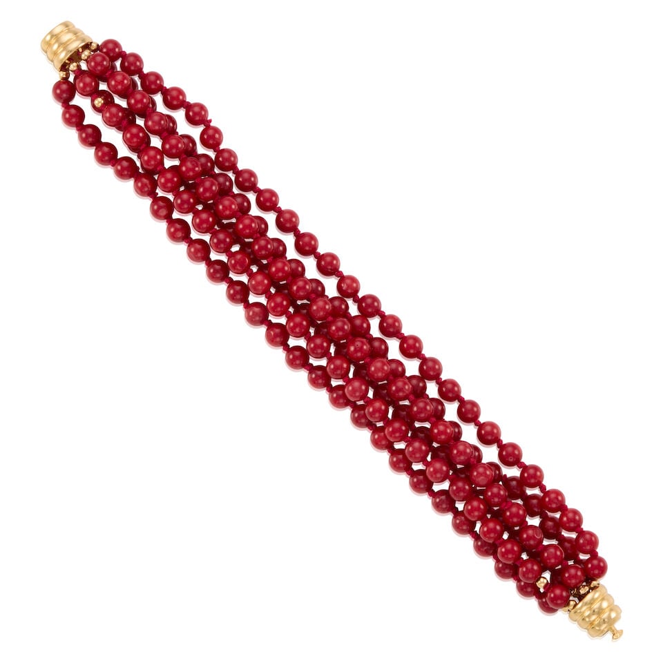 14K GOLD AND CORAL BRACELET: 14K GOLD AND CORAL BRACELET • 14k yellow gold • Numerous round coral beads measuring approximately 5.03 mm • Length 6 1/2 in. • Estimated gross weight: 32.1