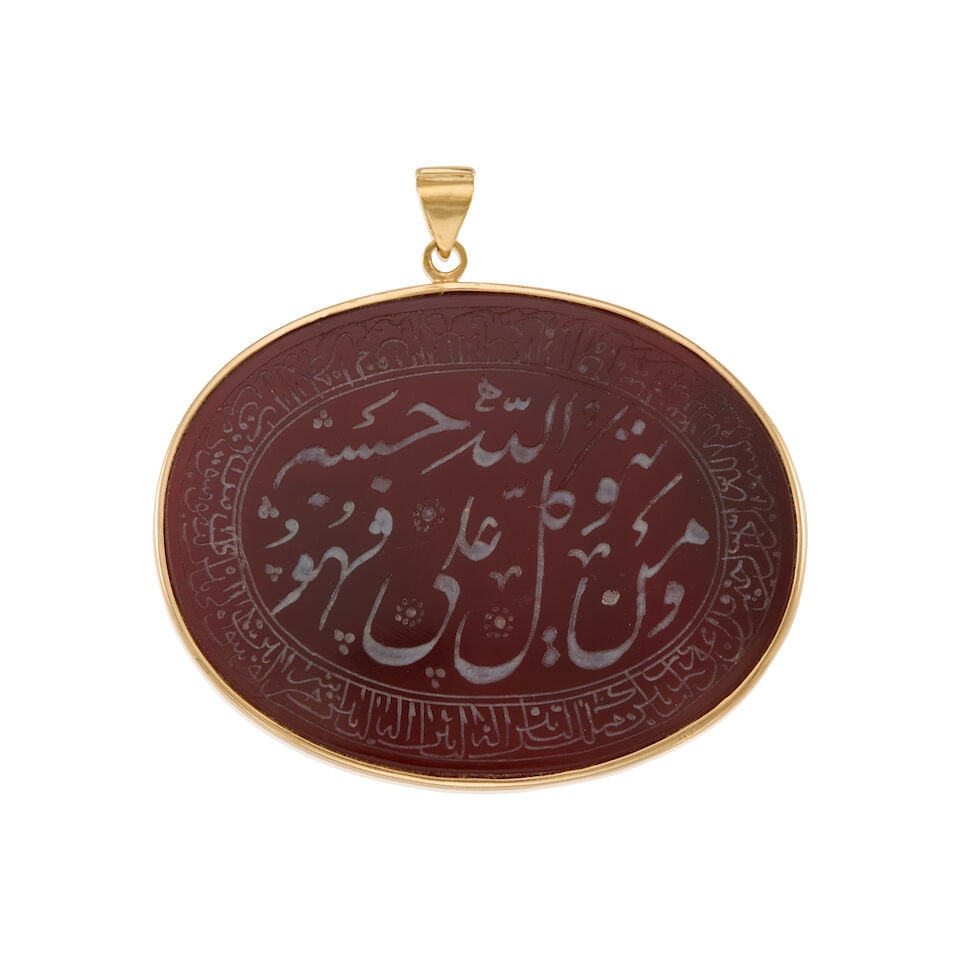 GOLD AND CARNELIAN CALLIGRAPHY PENDANT: GOLD AND CARNELIAN CALLIGRAPHY PENDANT • 16k yellow gold • 1 oval carved carnelian tablet • Measures 2 5/8 x 2 in. • Estimated gross weight: 21.9 grams Footnotes: Overall