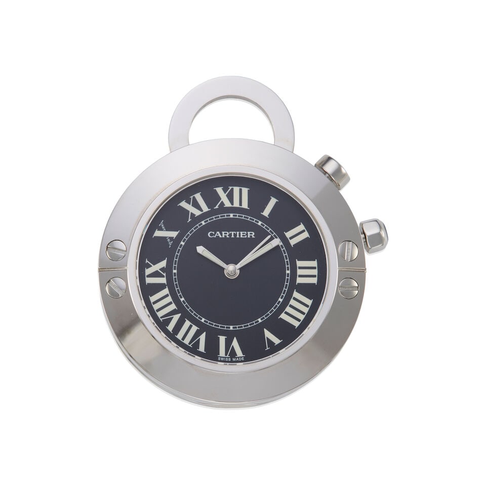 CARTIER: STAINLESS STEEL DESK CLOCK: CARTIER: STAINLESS STEEL DESK CLOCK • Stainless steel • One round sapphire measuring 4.70mm in diameter • Signed CARTIER, with serial numbers • Accompanied with signed box and 