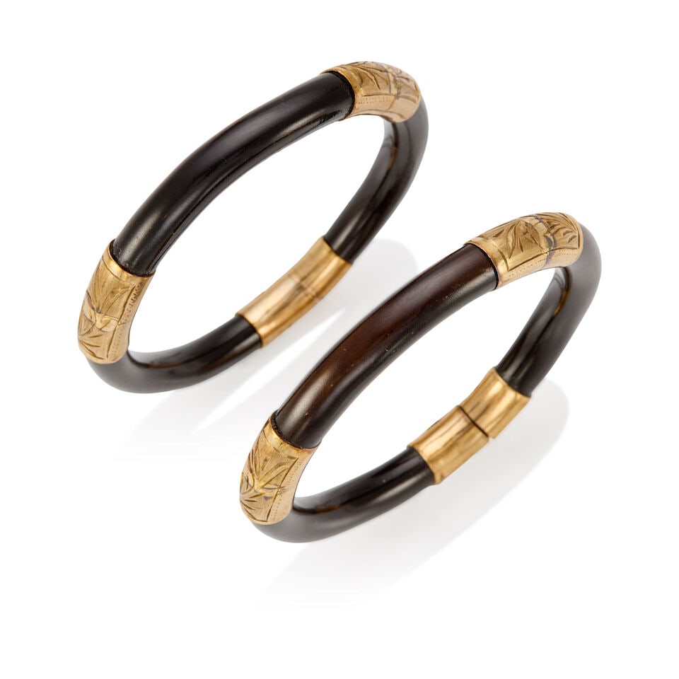 TWO LOW KARAT GOLD AND LACQUER WOOD BANGLES: TWO LOW KARAT GOLD AND LACQUER WOOD BANGLES • 9K yellow gold • Inner circumference 7 3/4 in. • Estimated gross weight: 47.9 grams Footnotes: Overall condition, very good Metal