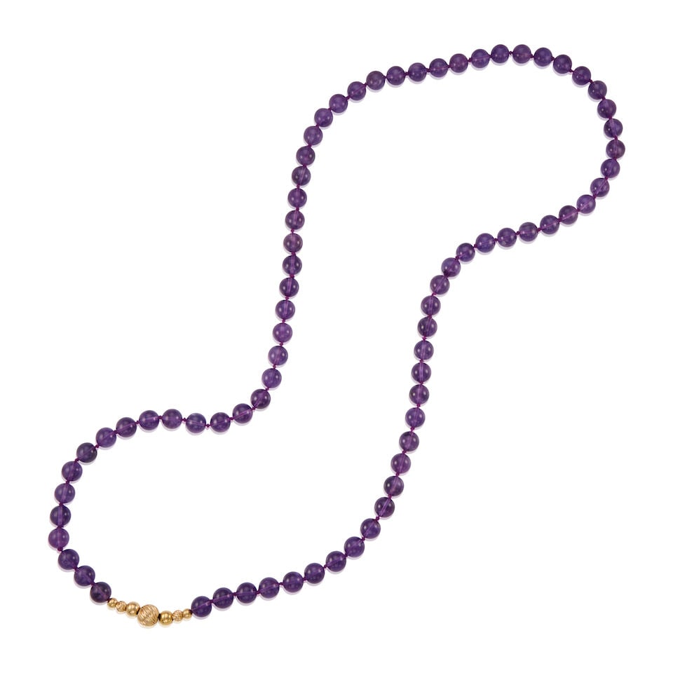 14K GOLD AND AMETHYST NECKLACE: 14K GOLD AND AMETHYST NECKLACE • Seven 14K yellow gold beads • Numerous amethyst beads measuring approximately 10.05mm in diameter • Length 17 1/2 in., no clasp • Estimated
