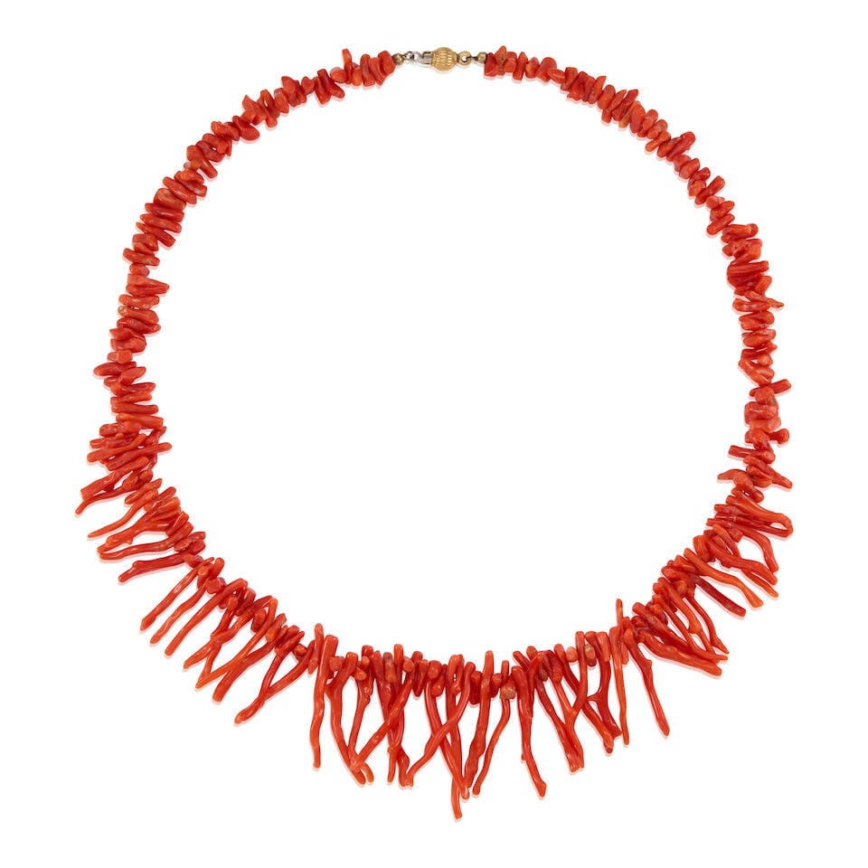 18K GOLD AND CORAL NECKLACE: 18K GOLD AND CORAL NECKLACE • 18K yellow gold • Numerous carved coral in various sizes and shapes, measuring from 6.50mm to 32.4mm in length • Length 18 1/2 in. • Estimated gro