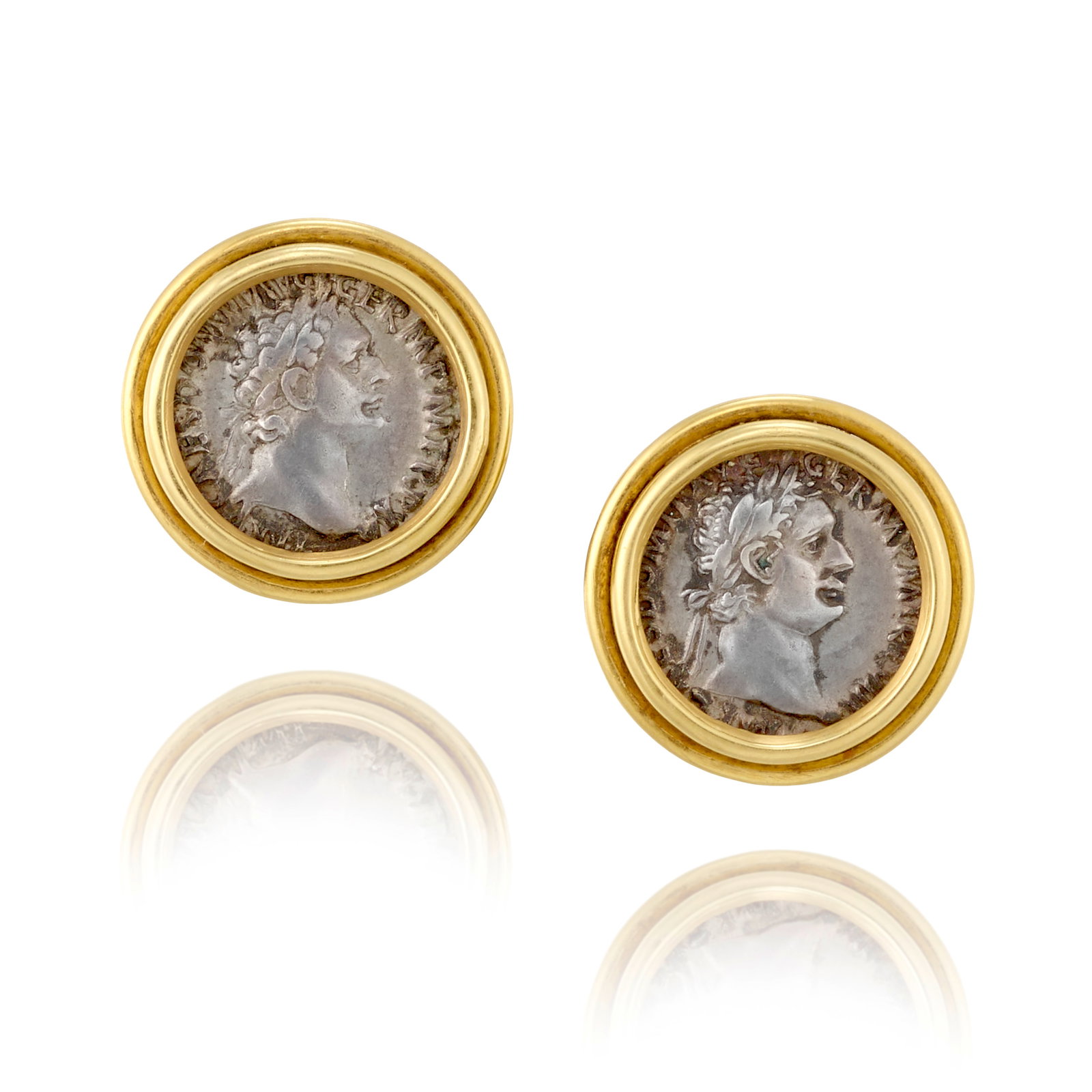 A PAIR OF 18K GOLD AND SILVER COIN EARRINGS: A PAIR OF 18K GOLD AND SILVER COIN EARRINGS Each featuring a silver denarius depicting Claudius, Roman Empire, circa 41-54 CE; with partial maker's marks and/or assay marks; measure 7/8 in. Footnotes: