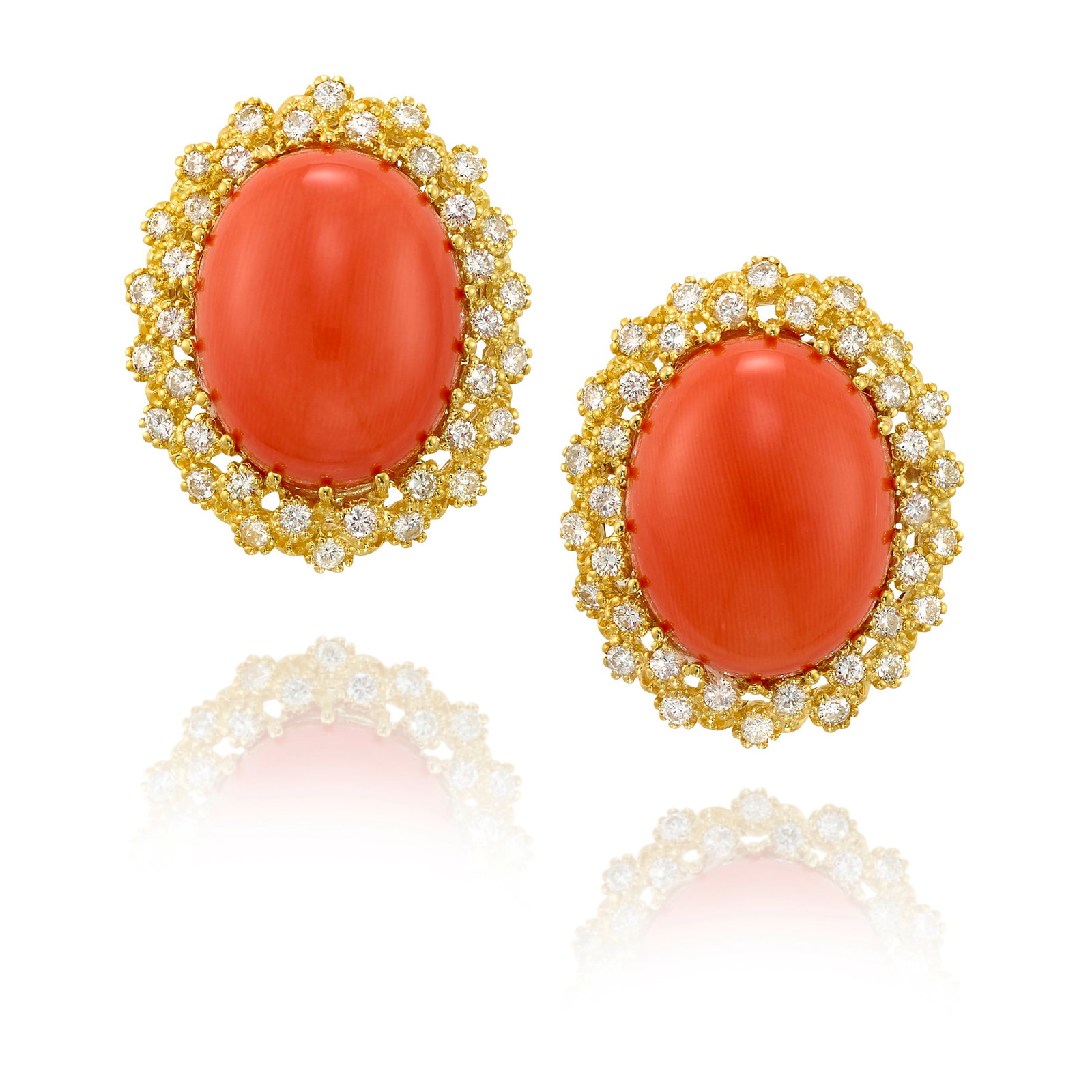 A PAIR OF CORAL AND DIAMOND EARRINGS: A PAIR OF CORAL AND DIAMOND EARRINGS Each set with oval-shaped cabochon coral, in double surrounds of round brilliant-cut diamonds; estimated total coral weight 37.80 carats; estimated total diamond