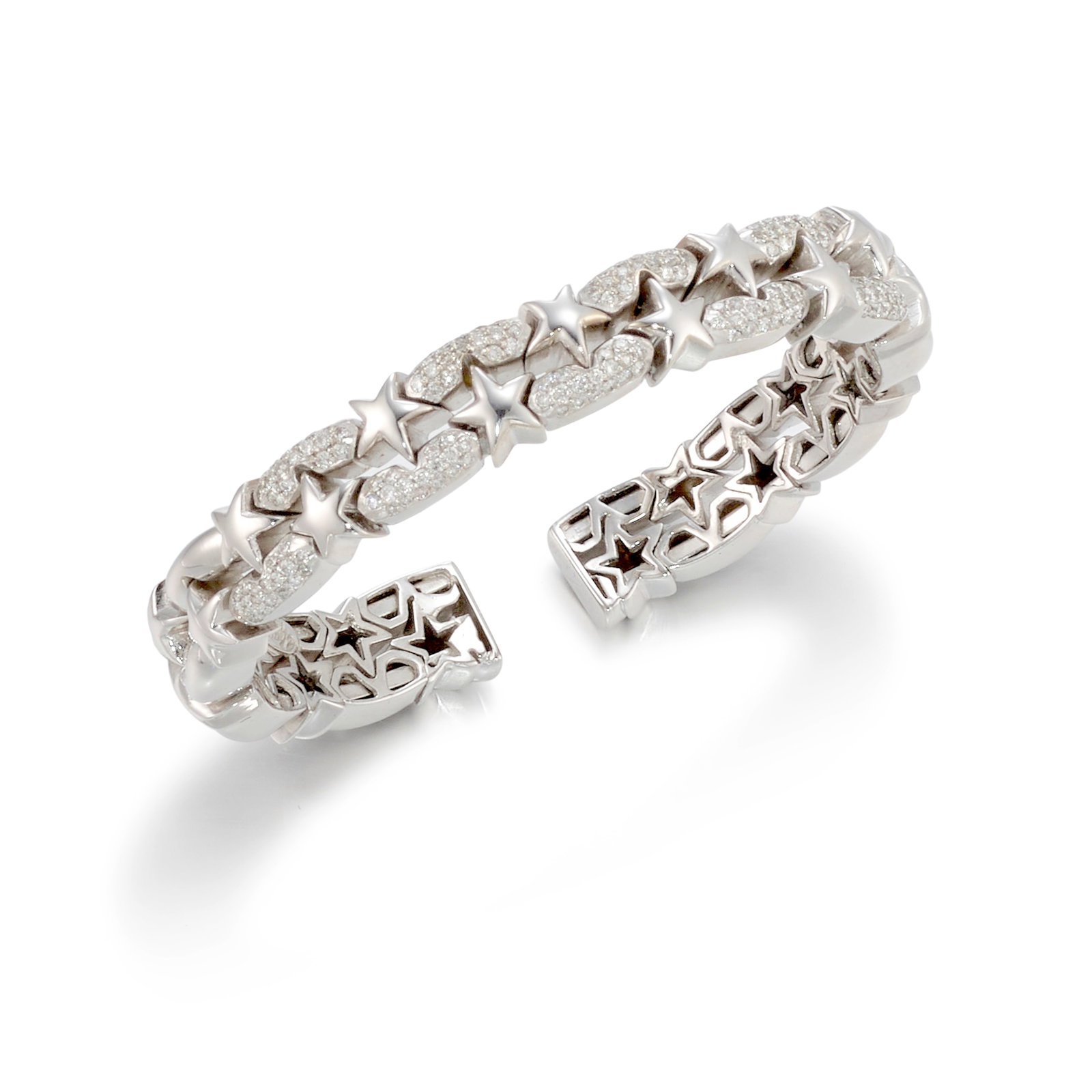 AN 18K WHITE GOLD AND DIAMOND BRACELET: AN 18K WHITE GOLD AND DIAMOND BRACELET A flexible cuff of star motifs, accented with round brilliant-cut diamonds; with maker's mark; estimated total diamond weight 0.75 carats; inner circumference 6 