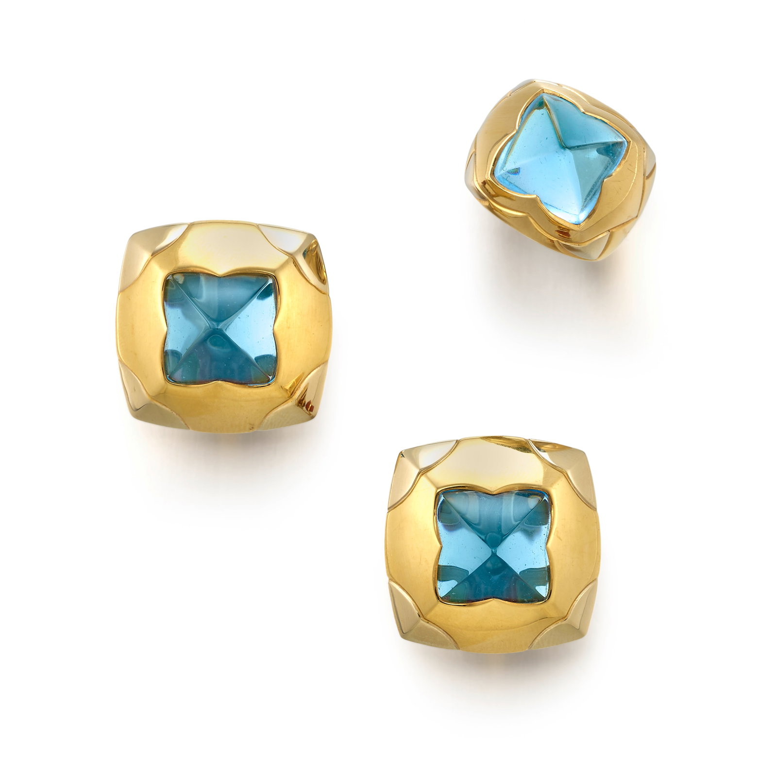 BULGARI: AN 18K BICOLOR GOLD AND BLUE TOPAZ 'PYRAMID' RING AND EARCLIP SET: BULGARI: AN 18K BICOLOR GOLD AND BLUE TOPAZ 'PYRAMID' RING AND EARCLIP SET All of high polish gold design, centering carved pyramidal blue topaz; all signed Bulgari; with maker's marks; with Italian r