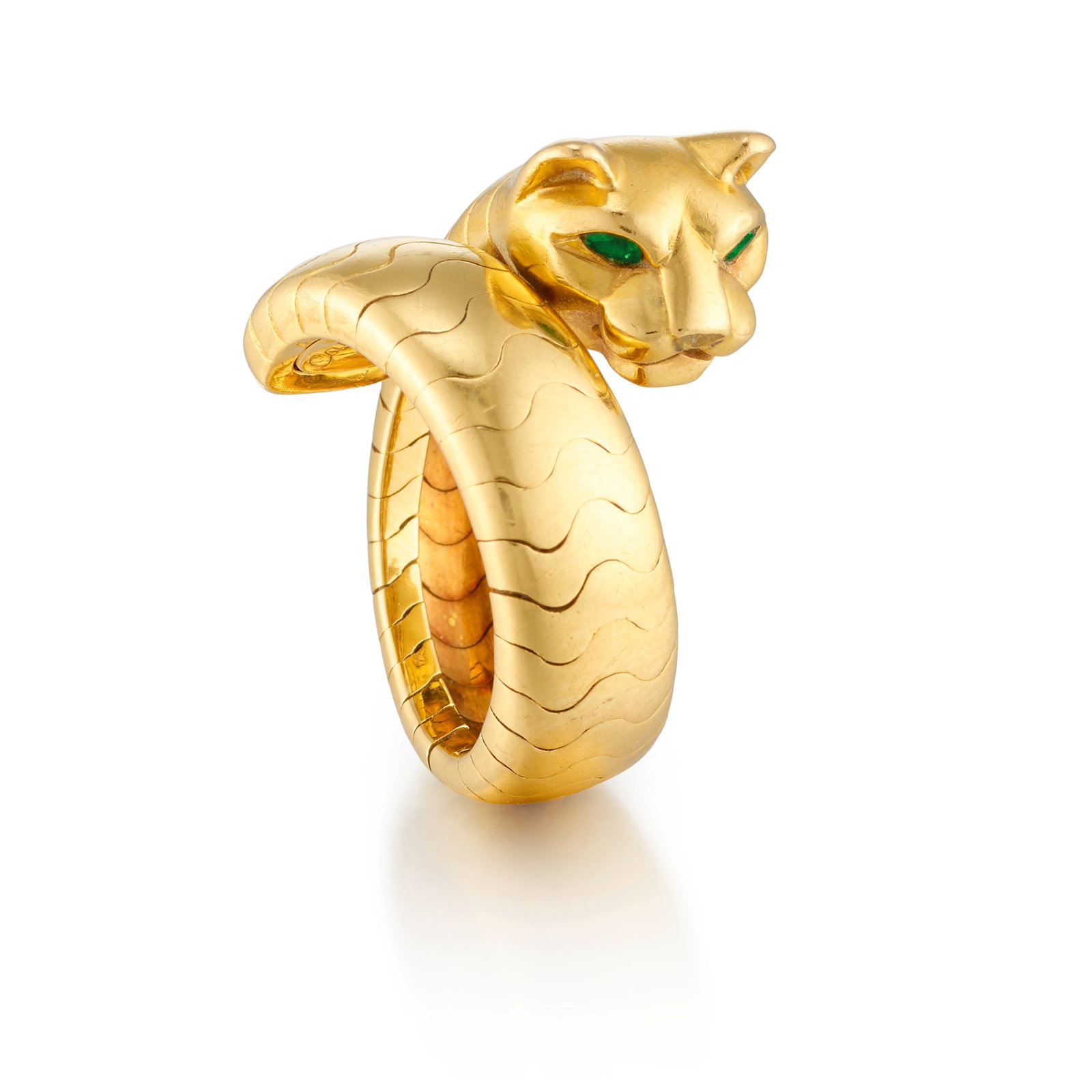 CARTIER: AN 18K GOLD AND EMERALD 'PANTHÈRE DE CARTIER' RING: CARTIER: AN 18K GOLD AND EMERALD 'PANTHÈRE DE CARTIER' RING Of flexible, bypass design, set with pear-shaped emerald eyes; signed Cartier; with maker's mark; with French assay mark; with serial n
