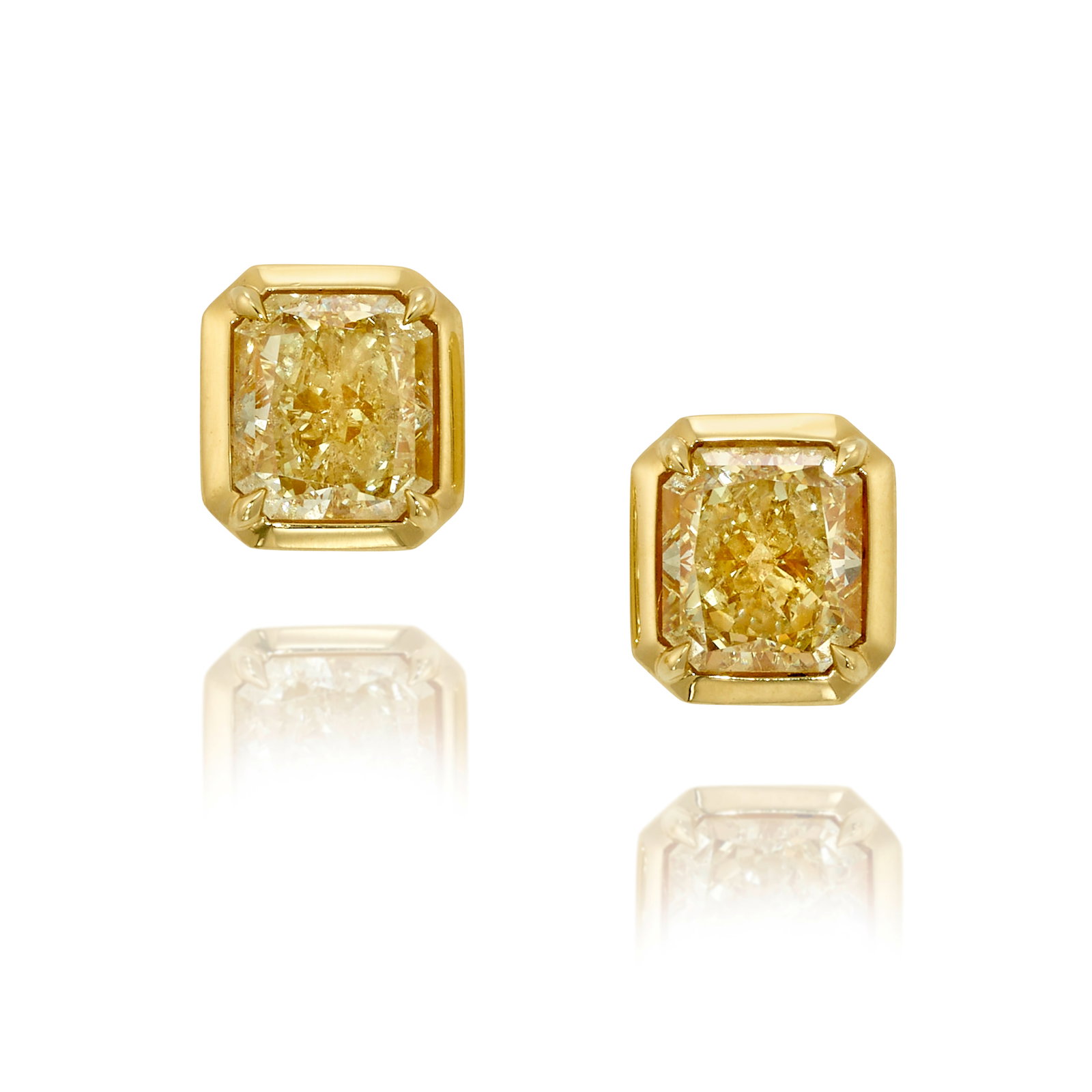 A PAIR OF DIAMOND EARRINGS: A PAIR OF DIAMOND EARRINGS Comprising cut-cornered rectangular, modified brilliant-cut diamonds, weighing 2.01 carats respectively; mounted in 18k gold; measures 3/8 x 5/16 in. Footnotes: Accompanied