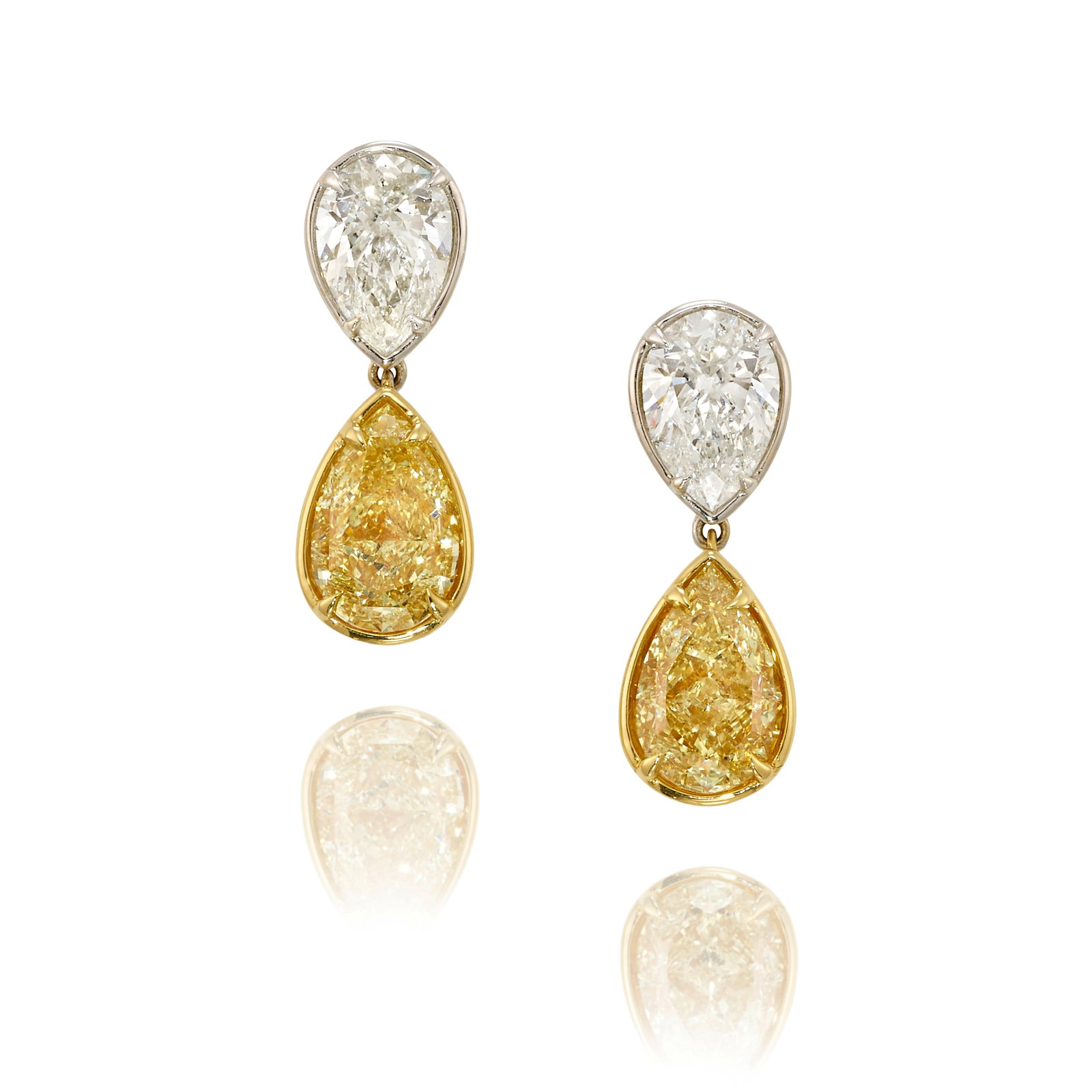 A PAIR OF DIAMOND EARRINGS: A PAIR OF DIAMOND EARRINGS Comprising pear-shaped diamonds, total weight 4.82 carats; mounted in 18k white and yellow gold; measures 3/4 x 1/4 in. Footnotes: Accompanied by GIA Report 5506670231,