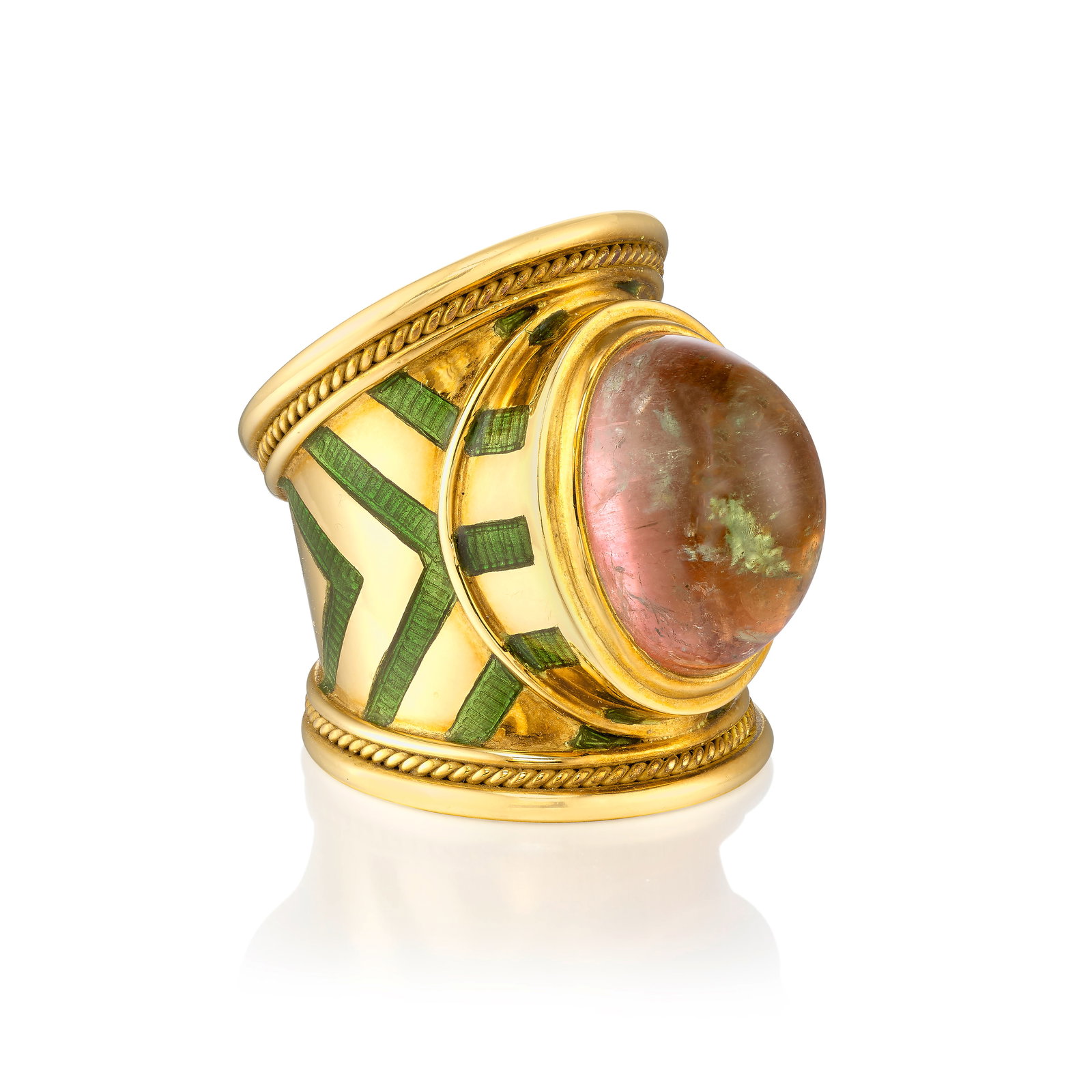 ELIZABETH GAGE: AN 18K GOLD, TOURMALINE AND ENAMEL RING: ELIZABETH GAGE: AN 18K GOLD, TOURMALINE AND ENAMEL RING Centering an oval-shaped, bicolor cabochon tourmaline, the tapered band accented with green enamel detail; signed Gage; with maker's marks; with