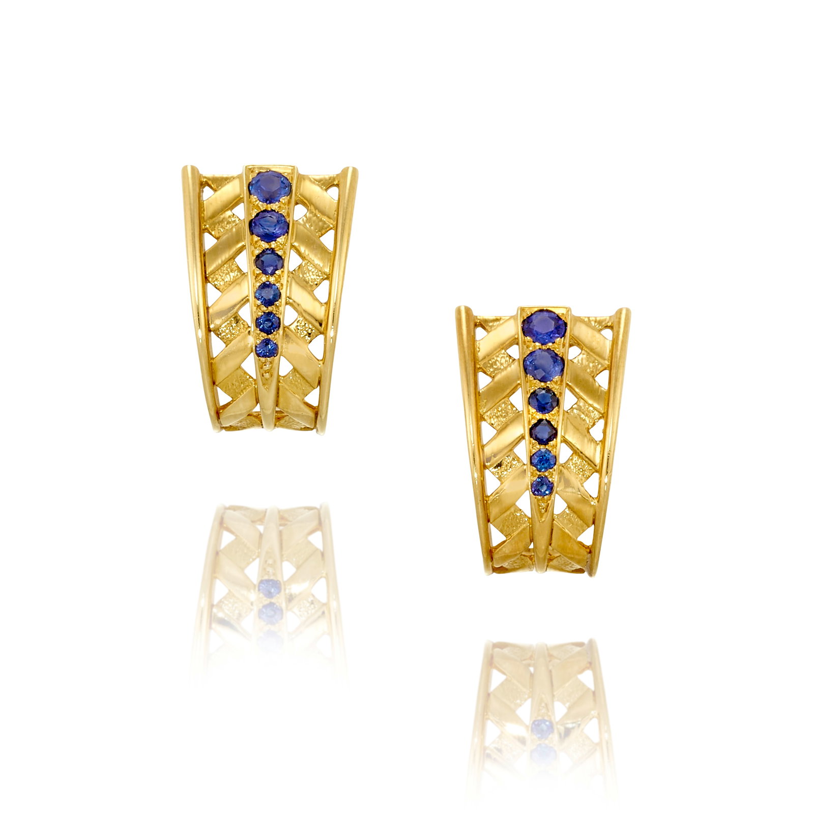 MAUBOUSSIN PARIS: A PAIR OF 18K GOLD AND SAPPHIRE EARCLIPS: MAUBOUSSIN PARIS: A PAIR OF 18K GOLD AND SAPPHIRE EARCLIPS Each of latticework design, centering rows of graduated round sapphires; signed Mauboussin Paris; with French assay marks; with serial number