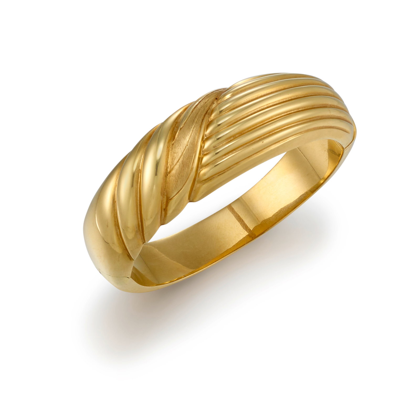 A 14K GOLD BRACELET: A 14K GOLD BRACELET A hinged cuff of contrasting fluted and wave designs; with Italian registered trademark; inner circumference 7 in.; center width 7/8 in. Footnotes: OVERALL CONDITION: Metal stamped