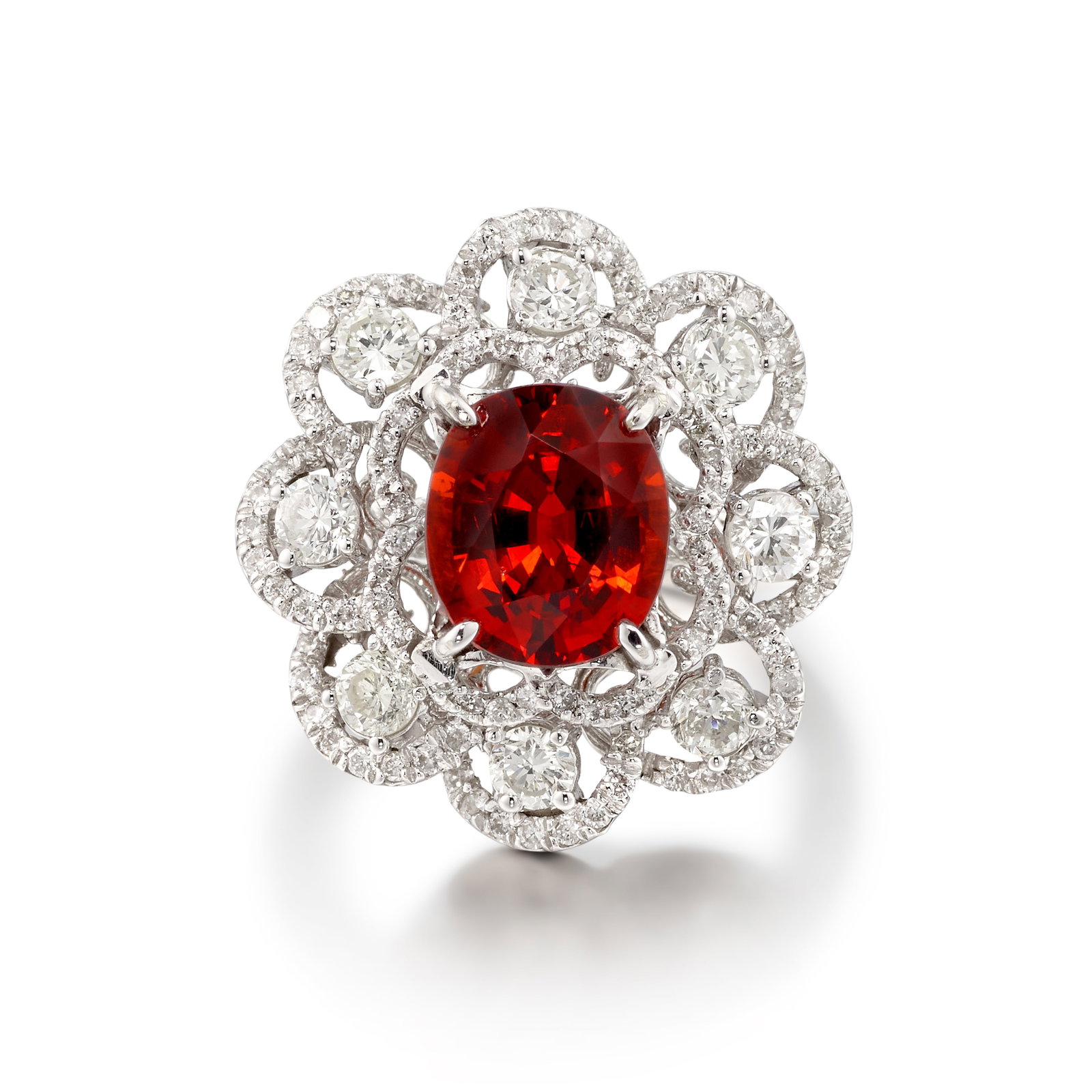 AN 18K WHITE GOLD, SPESSARTINE GARNET AND DIAMOND RING: AN 18K WHITE GOLD, SPESSARTINE GARNET AND DIAMOND RING Centering an oval-shaped spessartine garnet, weighing 3.70 carats, in an openwork surround accented with round brilliant-cut diamonds; estimated
