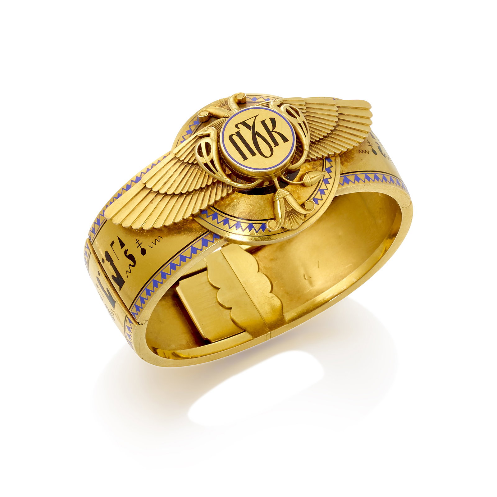 AN ENAMEL BRACELET, CIRCA 1880: AN ENAMEL BRACELET, CIRCA 1880 A hinged bangle designed with an Egyptian-inspired motif, with blue and black enamel detail; fabricated in 18k gold; inner circumference 6 1/4 in.; center width 1 1/4