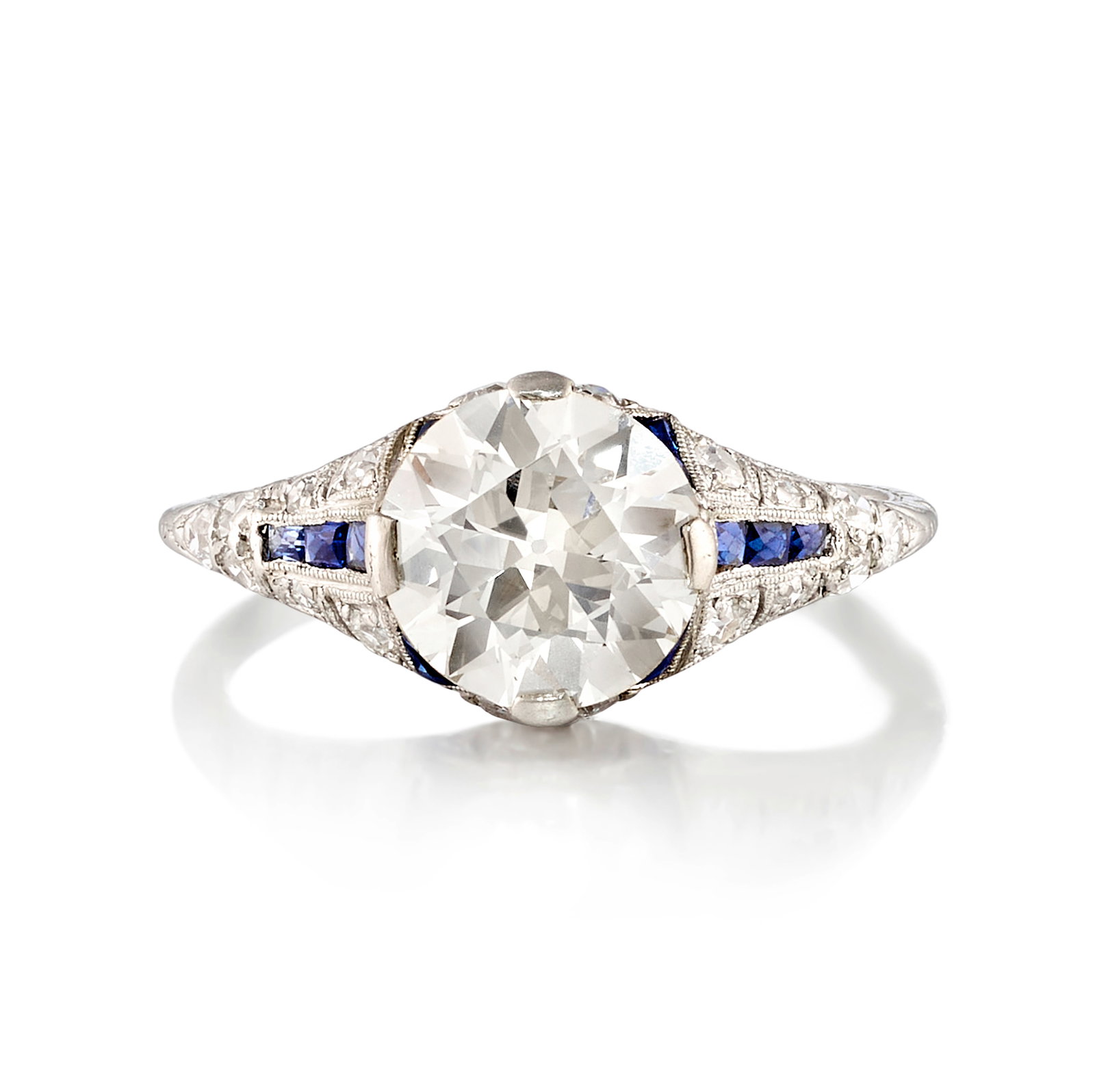 A DIAMOND AND SAPPHIRE RING, CIRCA 1915: A DIAMOND AND SAPPHIRE RING, CIRCA 1915 Centering a circular brilliant-cut diamond, weighing 2.42 carats, in a mounting accented with calibré-cut sapphires and single-cut diamonds; with partial