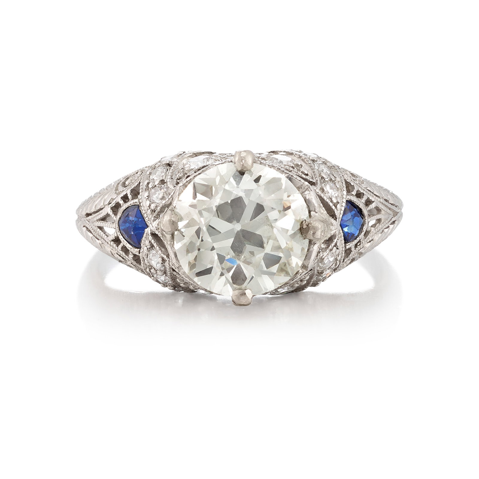 A PLATINUM, DIAMOND AND SAPPHIRE RING, CIRCA 1920: A PLATINUM, DIAMOND AND SAPPHIRE RING, CIRCA 1920 Centering an old European-cut diamond, weighing 2.09 carats, in an openwork mounting accented with old European and single-cut diamonds and