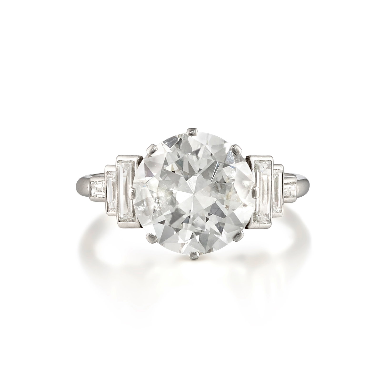 A DIAMOND RING, CIRCA 1925: A DIAMOND RING, CIRCA 1925 Centering a transitional-cut diamond, flanked by trios of baguette-cut diamonds; estimated center diamond weight 2.95 carats; estimated remaining diamond weight 0.50 carat;