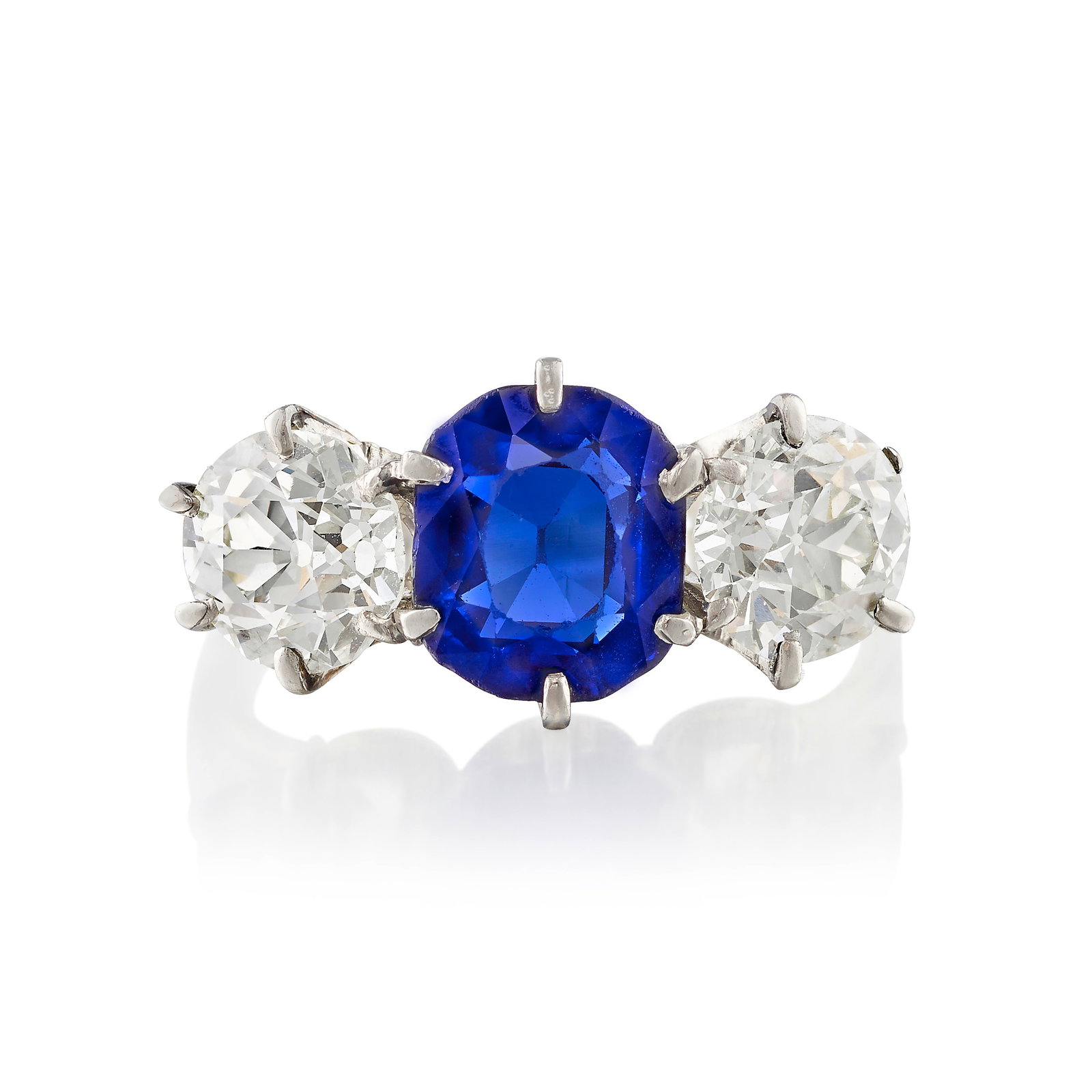 A SAPPHIRE AND DIAMOND RING, CIRCA 1915: A SAPPHIRE AND DIAMOND RING, CIRCA 1915 Centering a cushion-shaped sapphire, flanked by old European-cut diamonds; estimated sapphire weight 2.35 carats; estimated diamond weights 1.00 carat each;