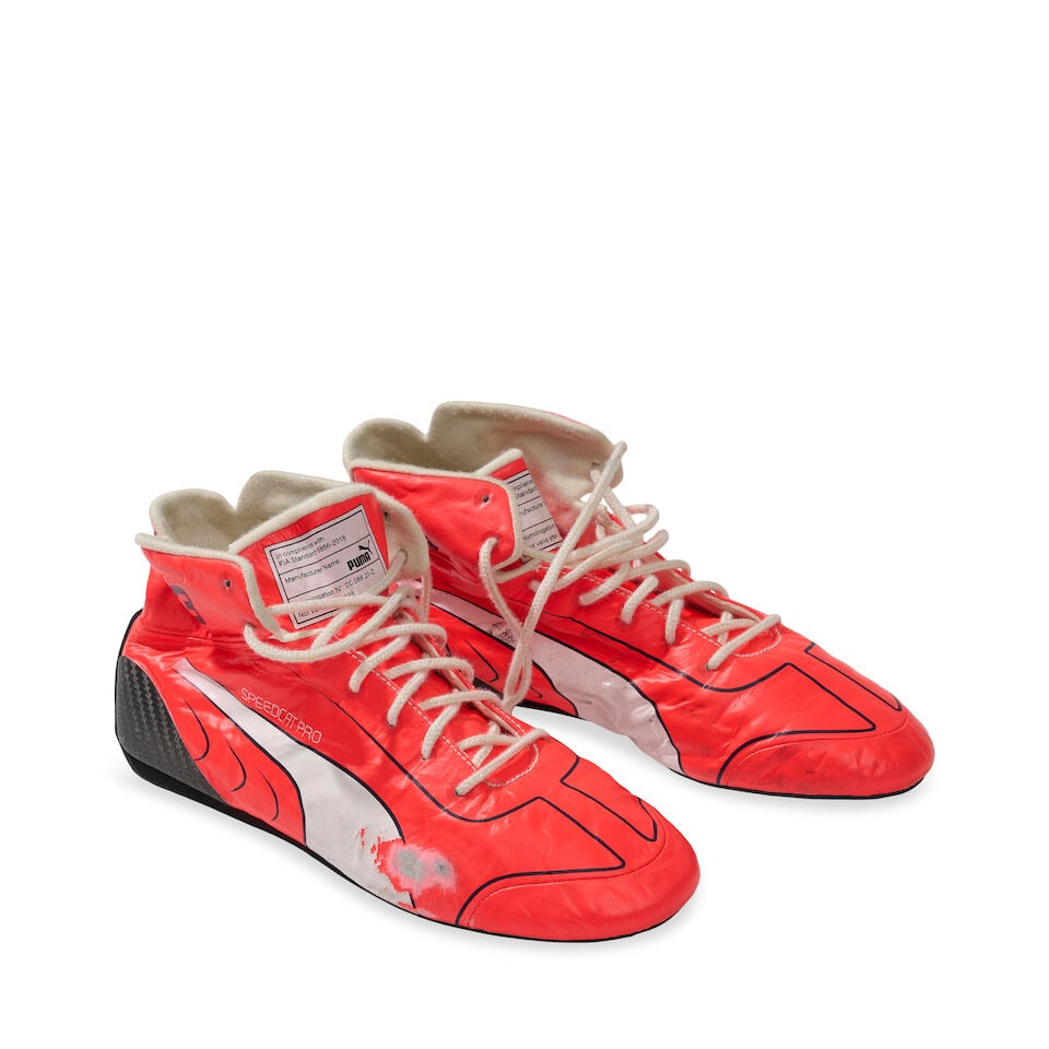 Max Verstappen's Red Bull Racing Honda 2021 First Championship winning season used race shoes,: Max Verstappen's Red Bull Racing Honda 2021 First Championship winning season used race shoes, in neon red with white ascents, by Puma, model Speedcat Pro, with heavy wear from use, details to tongue 