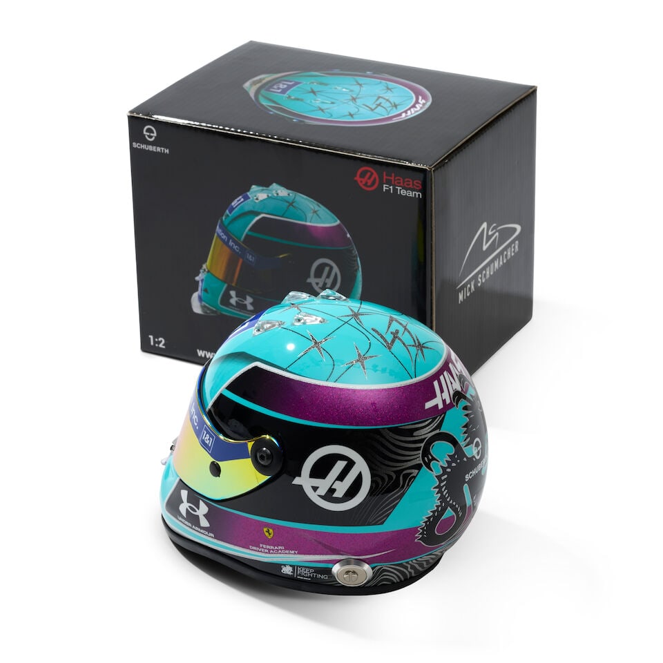 An official signed Mick Schumacher Haas Miami 2022 1/2 scale helmet,: An official signed Mick Schumacher Haas Miami 2022 1/2 scale helmet, signed to the helmet in black, with original box. For further information on this lot please visit Bonhams.com For further